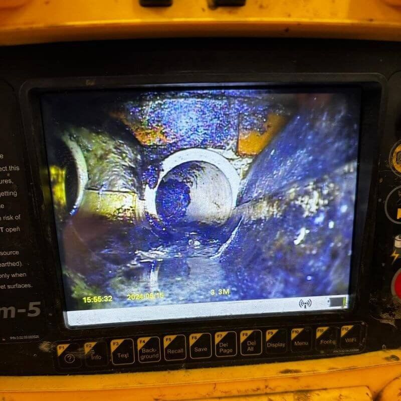 A drain survey monitor showing a pipe joint on screen during a CCTV inspection